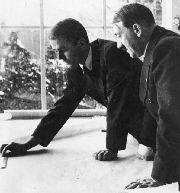 Albert Speer shows a project to Hitler at Obersalzberg. By Bundesarchiv – CC BY-SA 3.0 de
