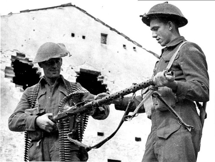 Canadian soldiers inspect a captured German MG34 machine gun.