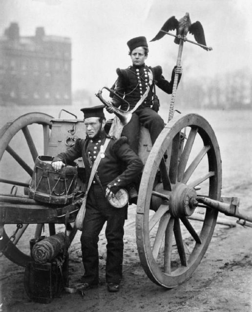 Trumpeter George Gritten, 11th Bn. and Trumpeter W. Lang, 12th Bn., Royal Artillery holding a Russian eagle flagstaff, which was brought back to England as a war trophy, 1856.