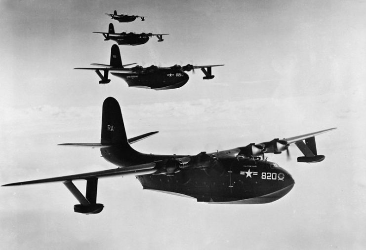 Four Martin JRM Mars aircraft, Philippine Mars (BuNo 76820), Marianas Mars (BuNo 76821), Hawaii Mars (BuNo 76823) and Caroline Mars (BuNo 76824) of U.S. Navy transport squadron VR-2 in flight.