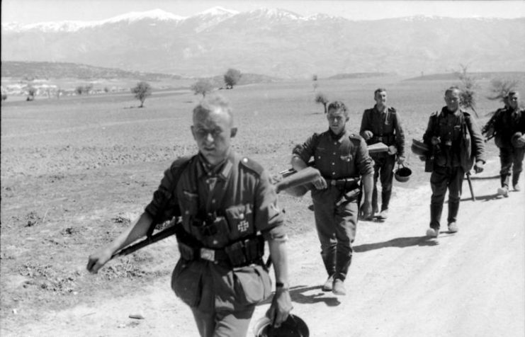 German infantrymen walking along a dirt road