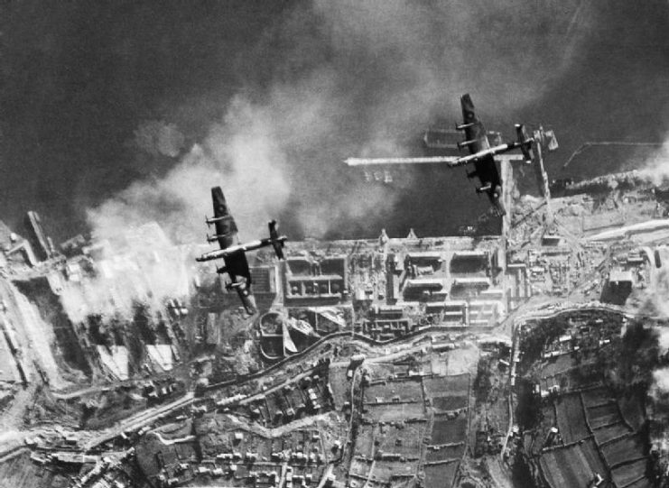 Handley Page Halifaxes of No. 35 Squadron RAF bombing the German battlecruisers SCHARNHORST and GNEISENAU in dry-dock at Brest, France.