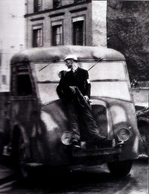 Member of the FFI (French Forces of the Interior), hiding behind a truck, during the Battle for Paris (August 1944). Unknown CC BY-SA 3.0