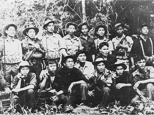 Viet Cong troops pose with new AK-47 assault rifles and American field radios