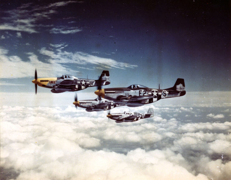 Four North American P-51 Mustangs in flight