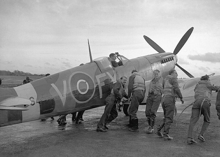 Pilots of 611 West Lancashire Squadron pushing an early Spitfire Mark IXb at Biggin Hill in late 1942