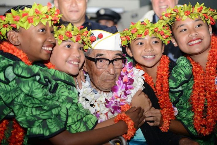 Ray Chavez, a 104-year-old Navy veteran and the oldest surviving Pearl Harbor veteran, poses for a photo after being greeted by several military members and personnel at the Honolulu International Airport, Dec. 3, 2016.