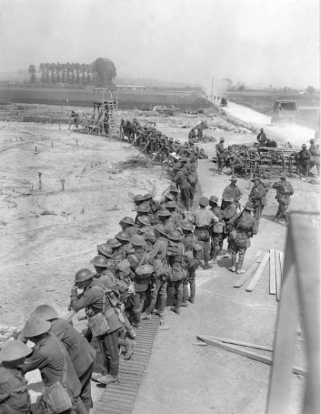 Soldiers studying the large contour map specially built between Petit Pont and Nieppe, which was constructed to give the troops a knowledge of the Messines battlefield in preparation for the battle which commenced the following morning.