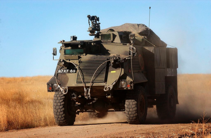 A Saxon Armoured Personnel Vehicle from the Cheshire Regiment moves at speed into battle. Soldiers from The Cheshire Regiment, 1 Mechanised Brigade 3 (UK) Armoured Division take part in Exercise Iron Anvil at the British Army Training Unit, Suffield, Canada.