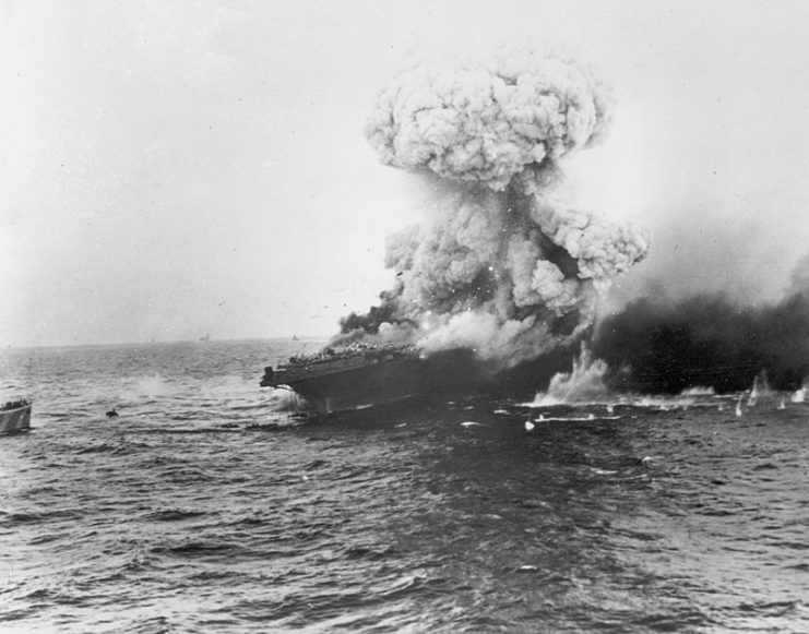 The American aircraft carrier USS Lexington explodes on 8 May 1942, several hours after being damaged by a Japanese carrier air attack.