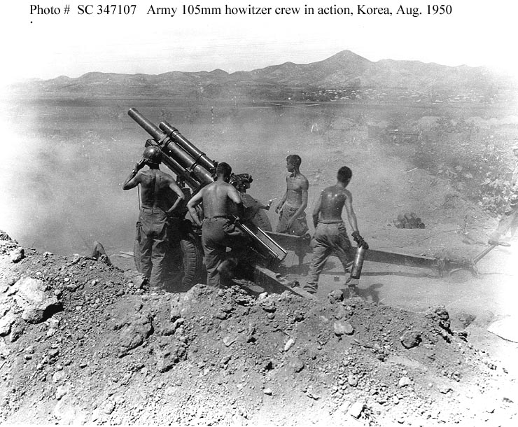 Gun crew of the 64th Field Artillery Battalion, 25th Infantry Division, fire a 105mm howitzer on North Korean positions near Uirson, South Korea.