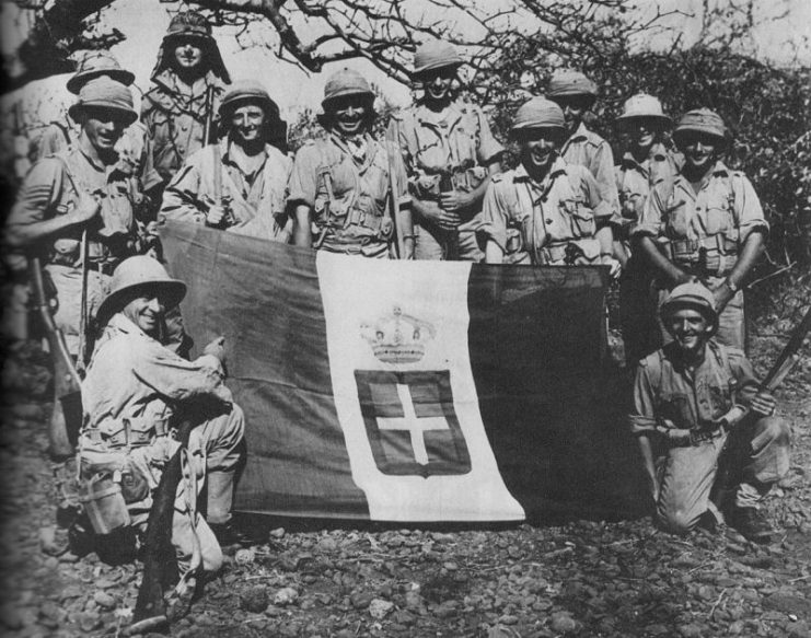 South African soldiers with a captured Italian flag, 1941.