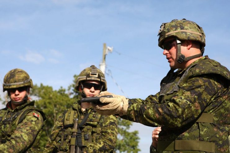 Canadian soldiers inspect a Hi-Power pistol during a training exercise in April 2009.