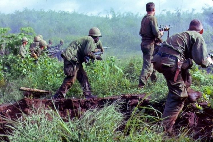 An infantry patrol moves up to assault a Viet Cong position after an attempted overrun of the artillery position by the Viet Cong