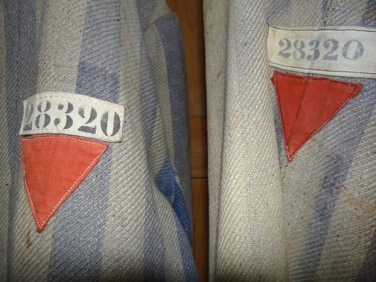 Uniforms with Red Triangles of Political Prisoners – Dachau Concentration Camp. Adam Jones, Ph.D. – CC BY-SA 3.0