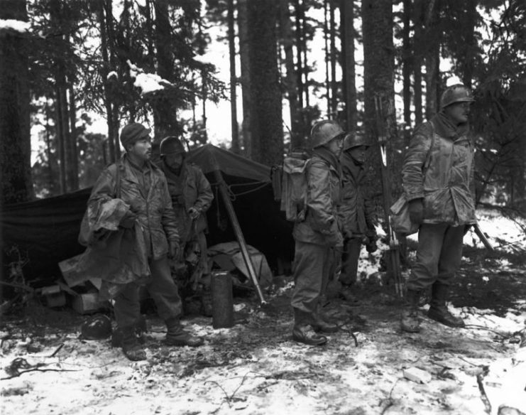 A Japanese-American unit moves out of its old command post. The unit, Company F, 2nd Battalion, 442nd Regimental Combat Team, is holding a section of the front lines near St. Die Area, France, 13 November 1944.
