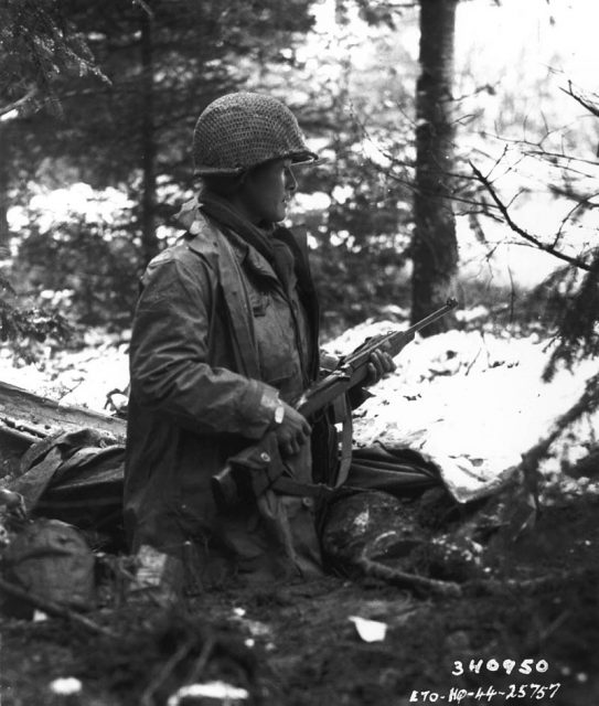 A squad leader checks for German units in France in November 1944.