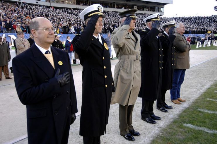Retired Navy SEAL and Medal of Honor recipient Robert E. Thornton (far right), renders honors at the playing of the National Anthem during opening ceremonies for the 107th playing of the Army vs. Navy football game.