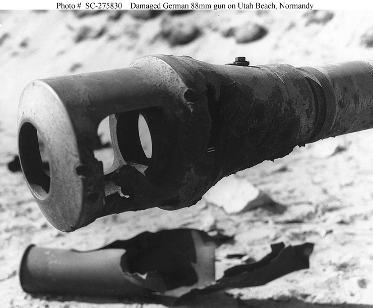 A damaged muzzle brake of a German 88mm gun, located in one of “Utah” Beach’s gun emplacements. Photographed on 15 September 1944, more than three months after U.S. troops landed there on “D-Day”