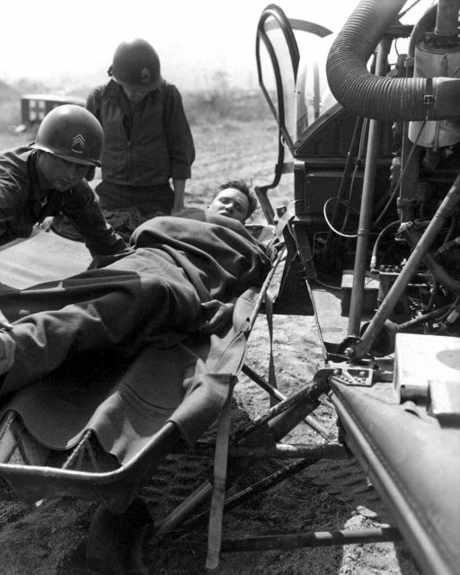 A wounded American is lifted onto a helicopter for evacuation to a base hospital.