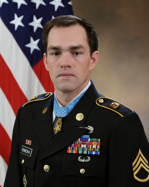 Clinton L. Romesha, the recipient of the Medal of Honor, poses for a portrait with the medal in the Army portrait studio at the Pentagon in Arlington, Va