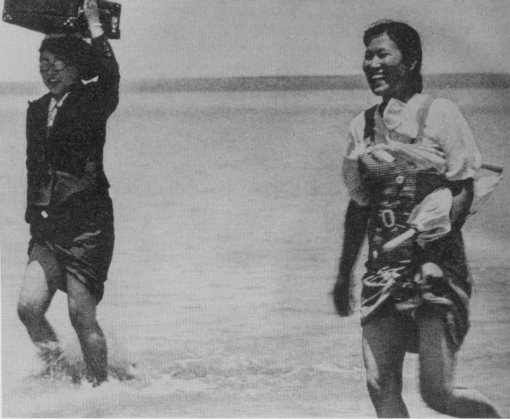 Comfort women crossing a river following soldiers.