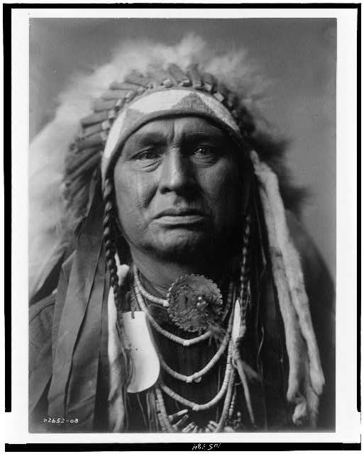 Edward S. Curtis portrait of White Man Runs Him, c. 1908.