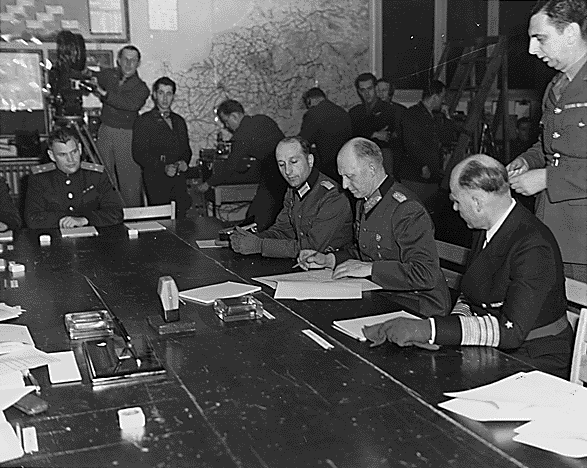 General Alfred Jodl signing the capitulation papers of unconditional surrender in Reims.