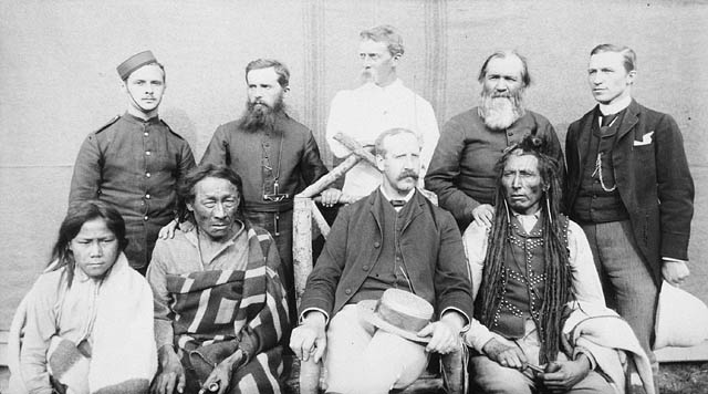 Group of nine taken in the square of the North-West Mounted Police Barracks, at Regina (Saskatchewan) Poundmaker, Big Bear, Big Bear’s son, Father Andre, Father Conchin, Chief Stewart, Capt. Deane, Mr. Robertson, and the Court Interpreter