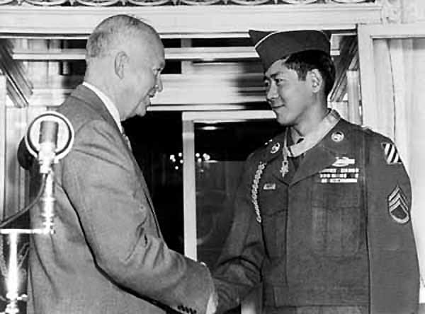 President Dwight Eisenhower congratulates Korean War veteran Army Staff Sergeant Hiroshi H. Miyamura after presenting him the Medal of Honor. Miyamura earned the medal as a corporal during an April 1951 battle that resulted in his capture by Chinese soldiers. His award was kept secret for his safety until after his repatriation in August 1953.