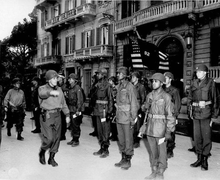 Major General Edward Almond, Commanding General of the 92nd Infantry Division, inspects his troops during a decoration ceremony, March 1945.