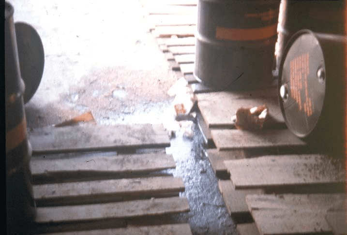 Out of every 10,000 drums of herbicide shipped to Vietnam, about 10 of them (0.1%) were received in a damaged or defective state. Leakage from these drums contaminated the docks and the semi-trailers used to haul them to the RANCH HAND bases (Photograph courtesy of Air Force Logistics Command, Kelly AFB, Texas).