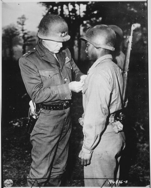 Patton pins a Silver Star Medal on Private Ernest A. Jenkins, a soldier under his command, October 1944