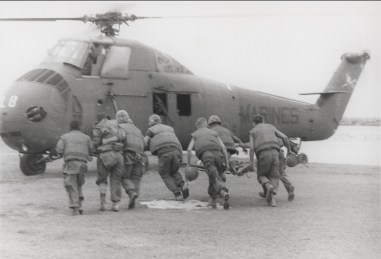 MEDEVAC: Leathernecks of the 2d Battalion, 4th Marines [2/4] help their wounded buddies to a medevac helicopter near Dong Ha during the heavy fighting that took place during Operation Napoleon/Saline.Photo: USMC Archives CC BY 2.0