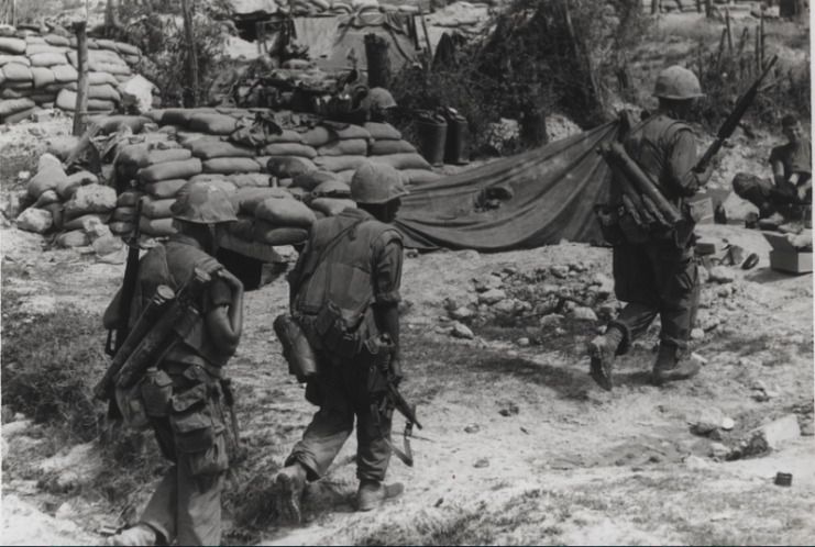 Coming In: A 4th Marine Regiment patrol enters its command post after conducting an early morning patrol along the Cau Viet River during Operation Napoleon/Saline.