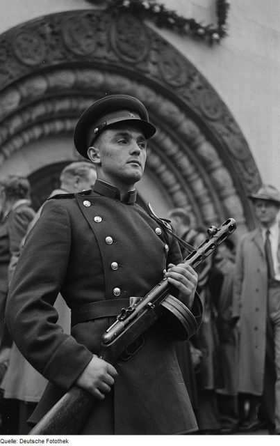 Soviet soldier with the submachine gun PPSh-41 in front of the portal of the Russian Memorial Church.