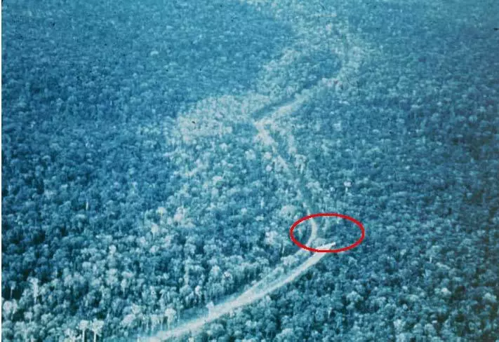 This photograph of a RANCH HAND UC-123B aircraft spraying vegetation along the east (in this N/S oriented view) side of Highway 1, south of Tuy Hoa in Phu Yen Providence in early 1965. Note the west side of the highway had been previously sprayed (Photograph courtesy of Plant Sciences Laboratory, Fort Detrick, Frederick, Maryland).