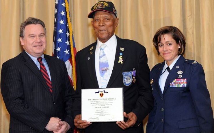 Tuskegee Airman Tech. Sgt. (Ret.) George Watson Sr. is presented the Purple Heart medal.