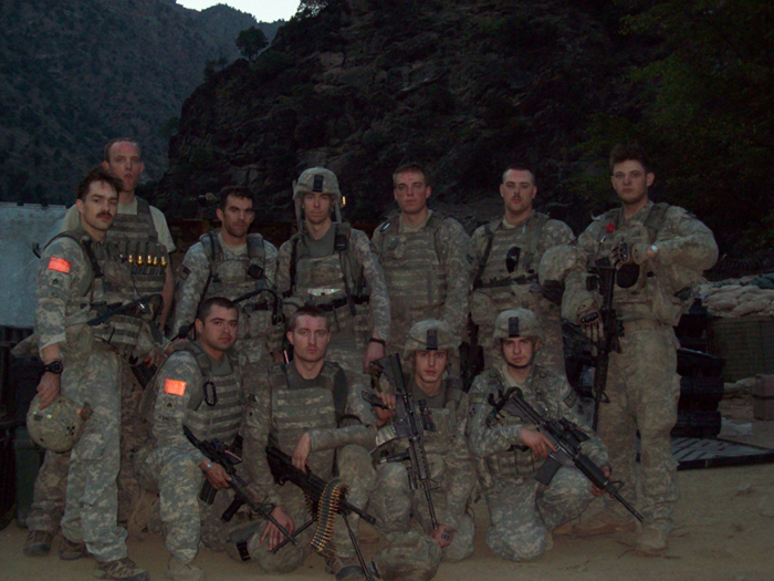 U.S. Soldiers with Bravo Troop, 3rd Squadron, 61st Cavalry Regiment, 4th Brigade Combat Team, 4th Infantry Division pose for a photo after a mission in Afghanistan in 2009. Standing, Left to right: Medal of Honor recipient Staff Sgt. Clinton L. Romesha, Spc. Thomas Rasmussen, Sgt. Brad Larson, 1st Lt. Andrew Bundermann, Pfc. Christopher Jones, Spc. Kugler and Spc. Knight. Kneeling, left to right: Sgt. Armando Avalos, Jr., Spc. Zach Koppes, Spc. Gregory, Pfc. Davidson. (U.S. Army Courtesy photo/Released)