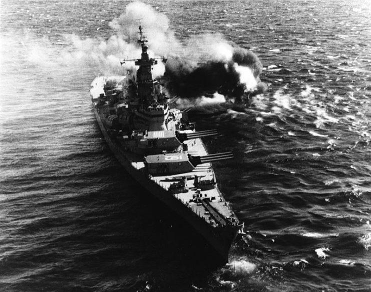 Iowa fires her 16-inch armament at coastal positions during her 1952 Korean deployment
