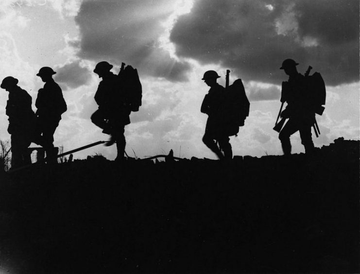 British soldiers moving forward during the Battle of Broodseinde. Photo by Ernest Brooks.