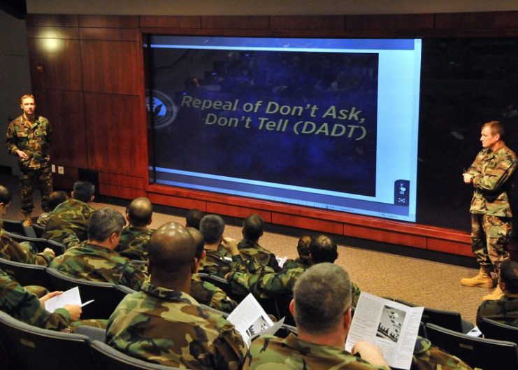 U.S. Navy Master Chief Britt K. Slabinski, left, command master chief, and Capt. Timothy G. Szymanski, commanding officer of Naval Special Warfare Group 2, kick off the “Don’t Ask, Don’t Tell” repeal all hands training at Joint Expeditionary Base Little Creek-Fort Story in Norfolk, Va., March 25, 2011.