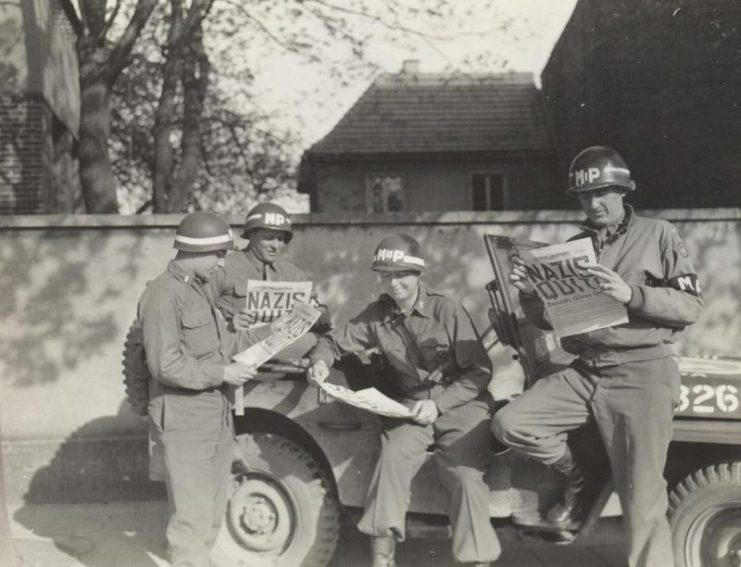 US MPs reading about German surrender