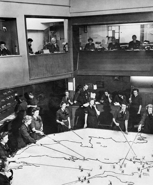 Operations Room at No. 10 Group Headquarters, Rudloe Manor (RAF Box), Wiltshire, showing WAAF plotters and duty officers at work.