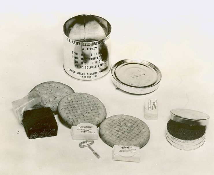 A 1941 C Ration B unit, with contents: 3 biscuits, cellophane wrapped chocolate fudge, 3 pressed sugar cubes, and a small tin of soluble (instant) coffee.