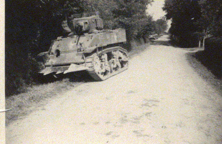 A knocked-out M5 Stuart light tank, fitted with a Culin-style “cutter” (August 1944, Ahuillé, France)
