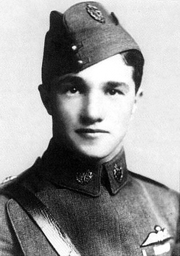 Head-and-shoulders portrait of young dark-haired man in military uniform wearing forage cap
