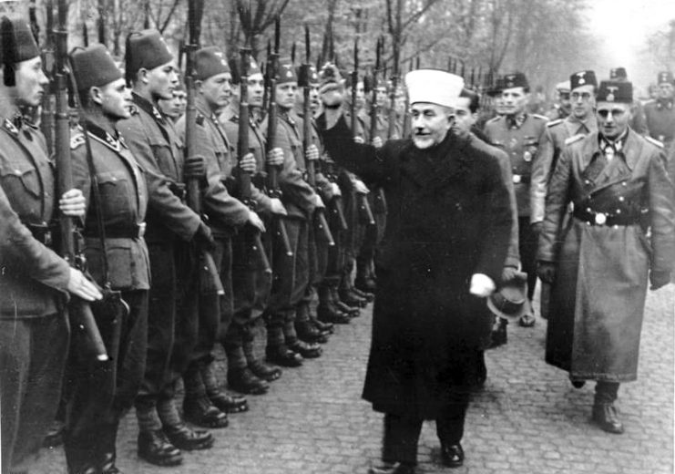 November 1943 al-Husseini greeting Bosnian Waffen-SS volunteers with a Nazi salute. On the right is SS General Karl-Gustav Sauberzweig. Bundesarchiv, Bild 146-1980-036-05 / Unknown / CC-BY-SA 3.0