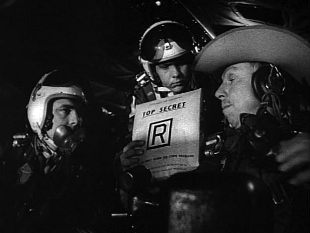 Capt. “Ace” Owens (Shane Rimmer), Lt. Dietrich (Frank Berry), and Major T. J. “King” Kong (Slim Pickens) about to open Wing Attack Plan R in Stanley Kubrick’s 1964 film, Dr. Strangelove.