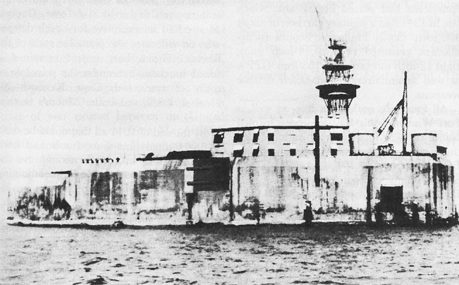 Fort Drum. Temporary wooden barracks on the fort’s deck are visible near the fire control tower